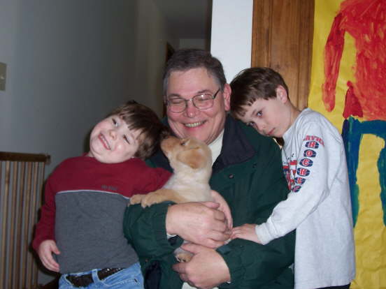 Normand holds Sparky with Alex and Max looking on