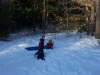 Cousins sledding together